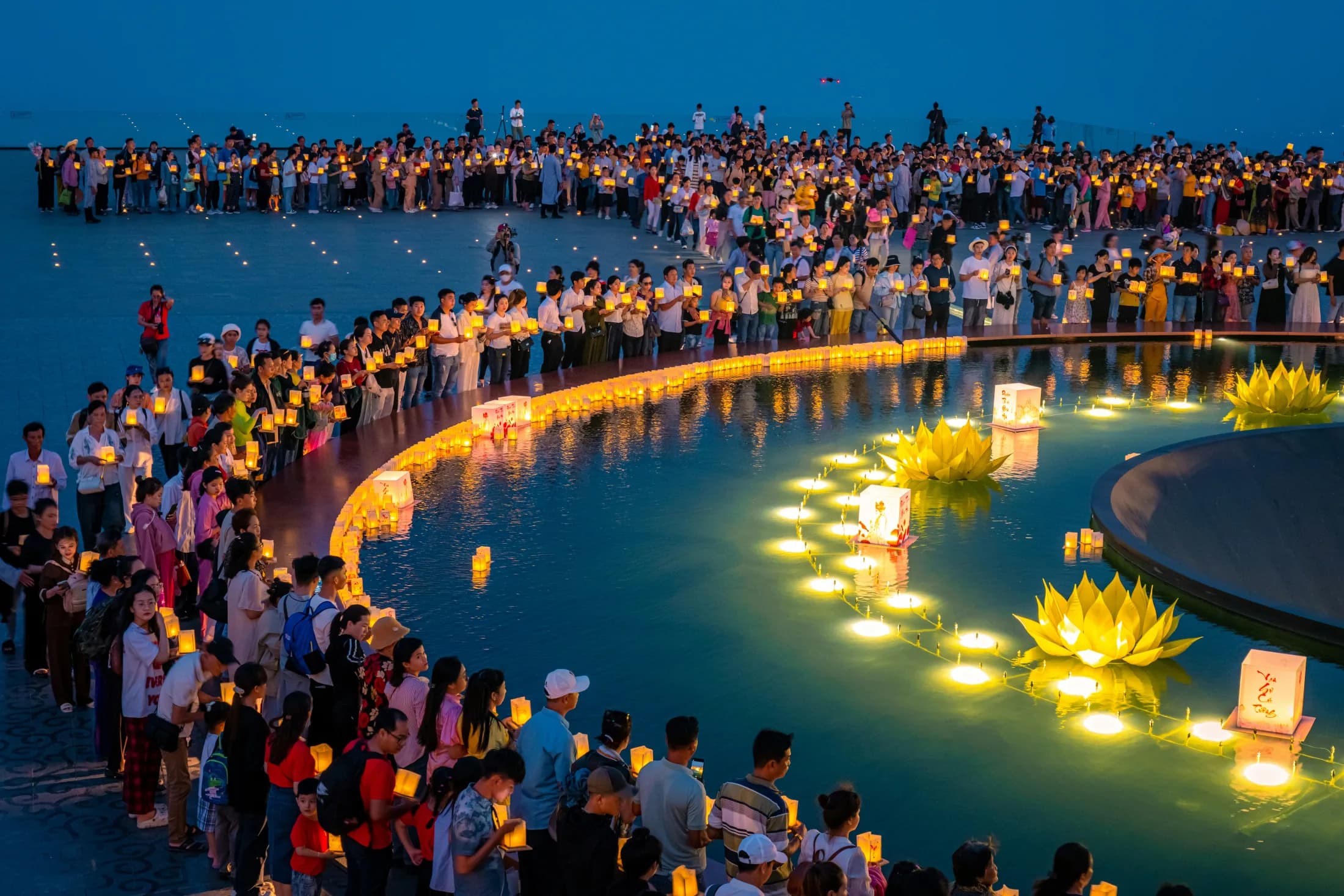 Floating lights glowing on water during Loy Krathong