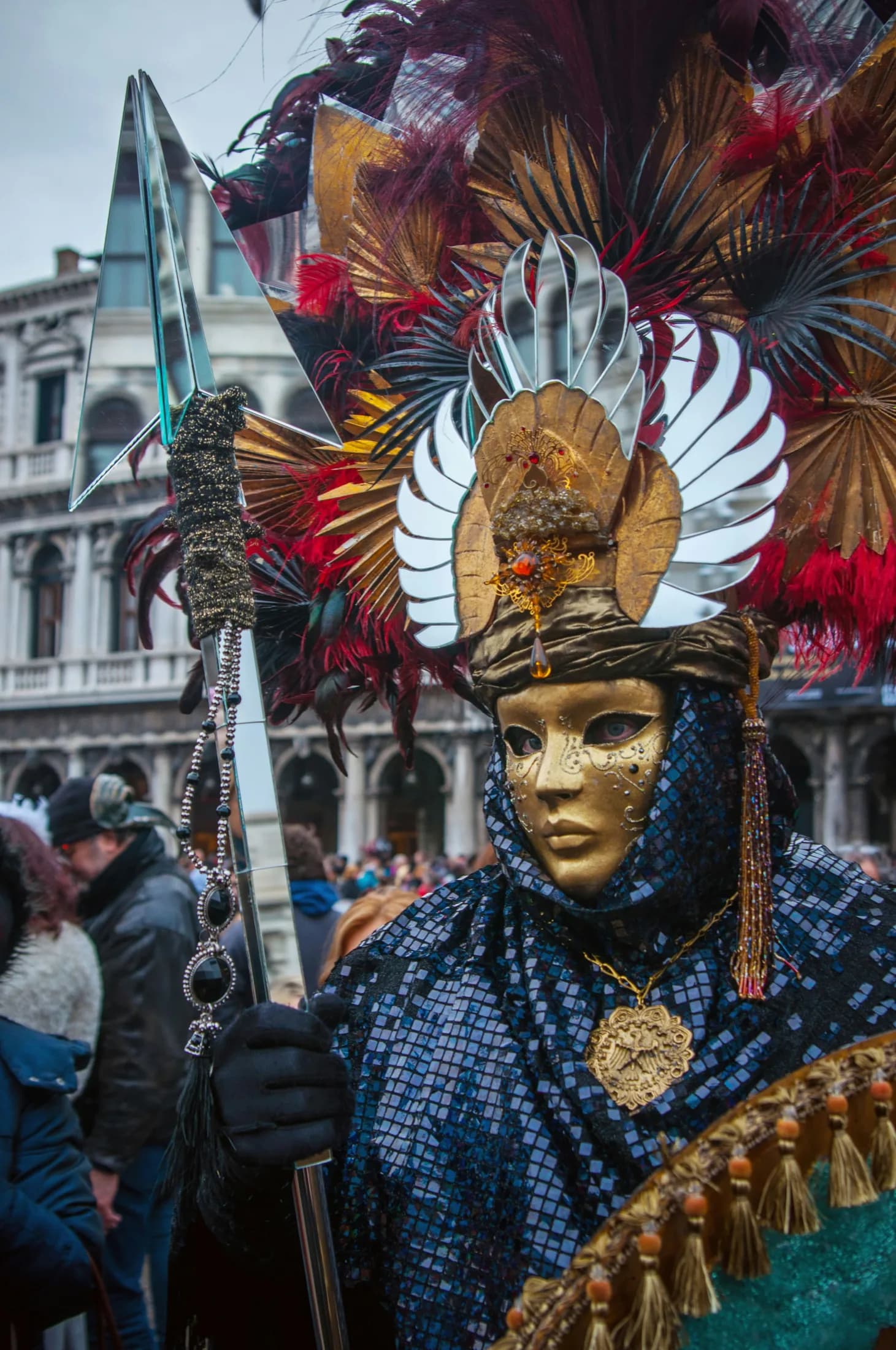 A masked Venice Carnival performer in ornate dress