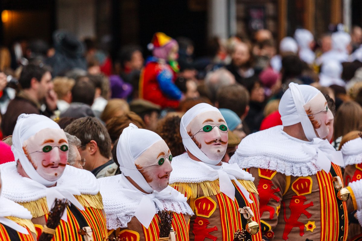 Gilles de Binche wearing traditional wax masks lined up during the Carnival of Binche, Belgium