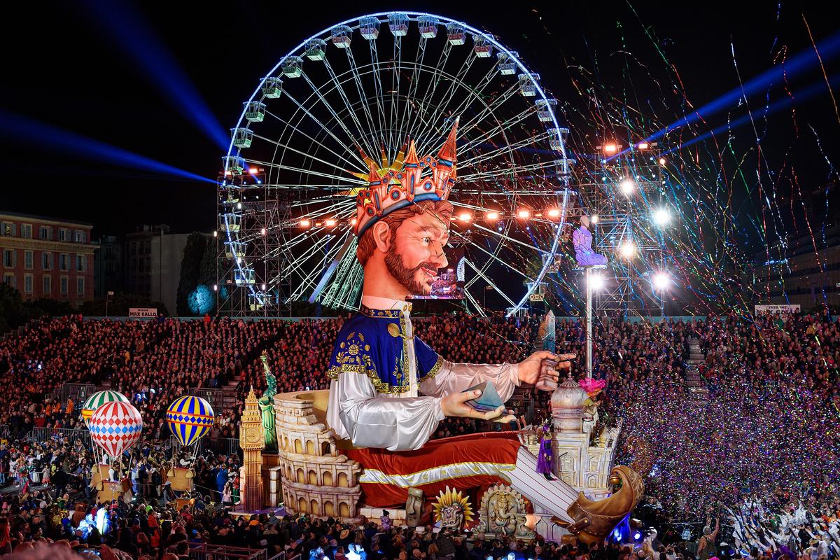Illuminated Char du Roi float during the night parade at Carnaval de Nice, France